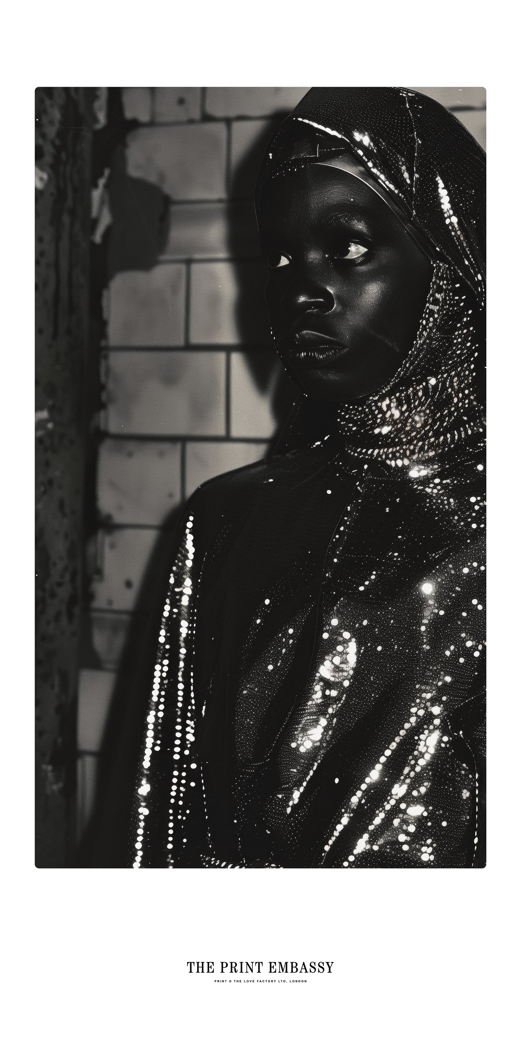 A nun wearing a fabulous shiny black outfit with a textured background, waiting for the subway, circa 80sm sepia tone. The Print Embassy logo is placed below the image.