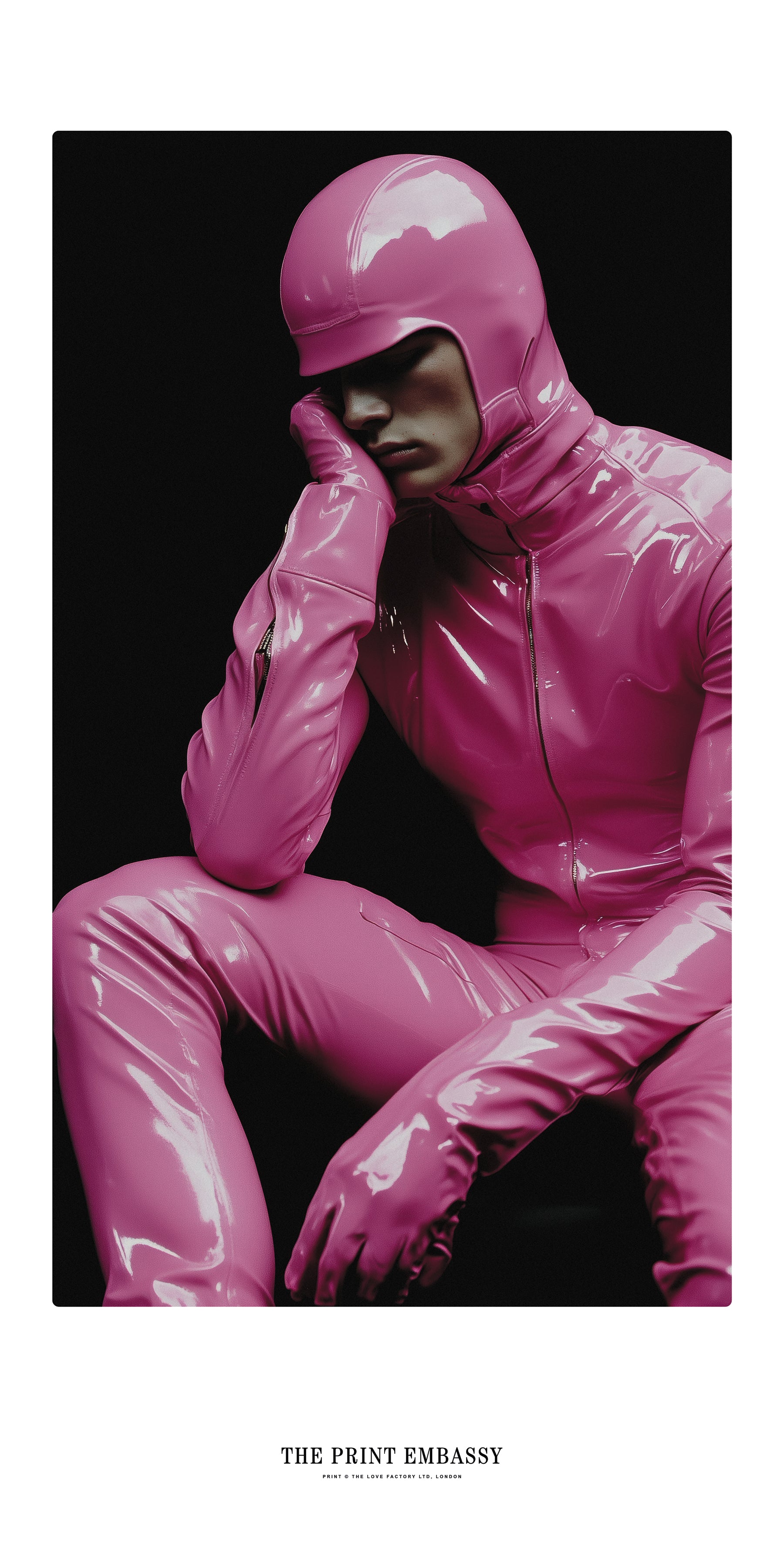 An oversized poster showing a bored guy wearing a shiny pink full-body latex suit, against a black background. The Print Embassy logo sits at the bottom.