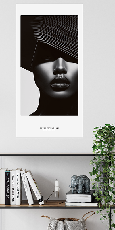 An oversized Poster of a stylized face with a black frame on a white wall above a shelf with books and decor. Very reminiscent of a Vogue Cover from the 90s.