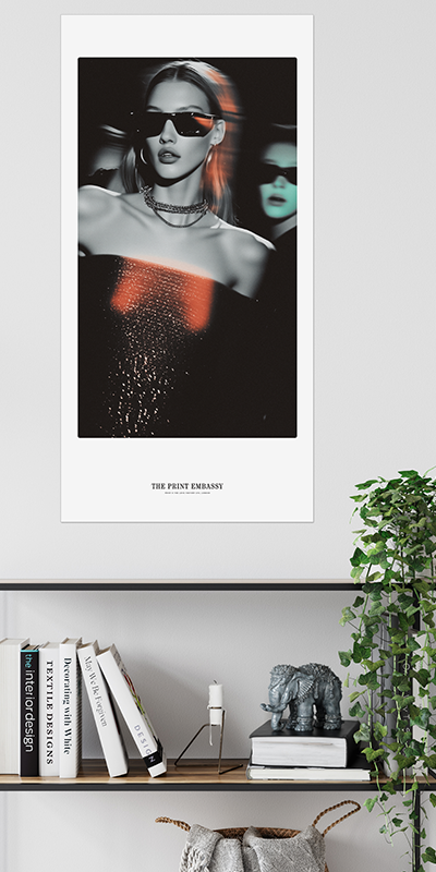Poster of a stylish woman with sunglasses on a wall above a shelf with books and decor.