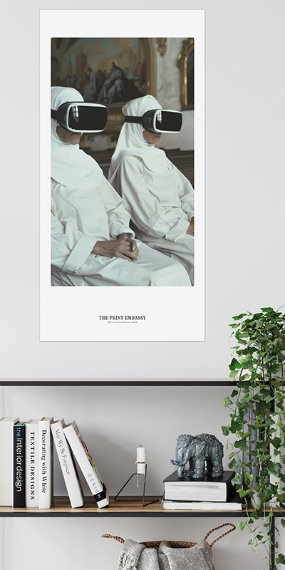 Poster of two nuns in white robes with VR gear on their heads. The large oversized print is placed on a wall above a shelf with books and decor.