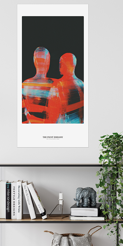 Framed artwork of two abstract figures in red and blue on a black background, displayed on a wall above a shelf with books and decor.